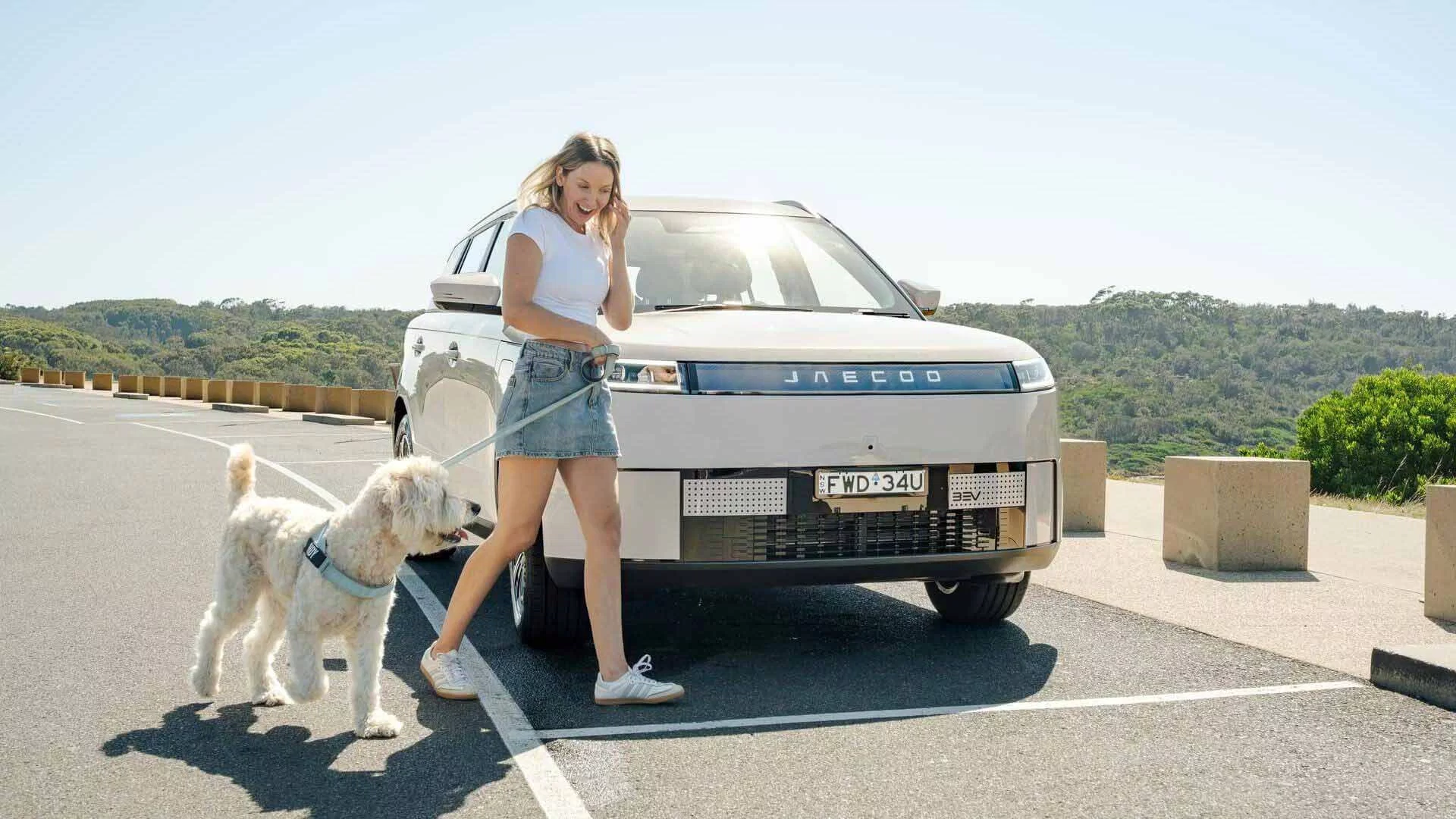 JAECOO J5 EV parked outdoors with owner and dog